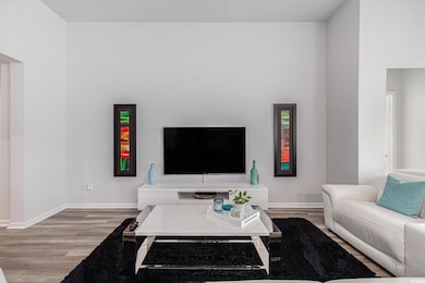 Living room with light wood finished floors and baseboards