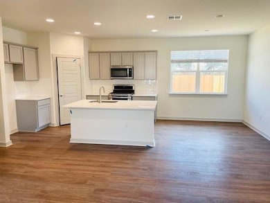 Kitchen with stainless steel appliances, gray cab