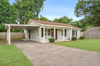 Single story home with a carport, covered porch, a