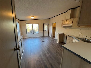 Kitchen with a sink, lofted ceiling, dark wood-sty