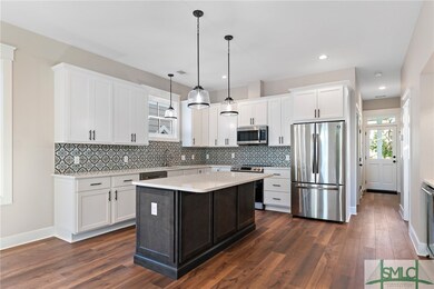 Kitchen with stainless steel appliances and quartz