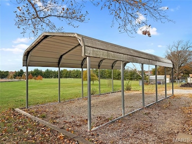View of property's community with a yard and a carport