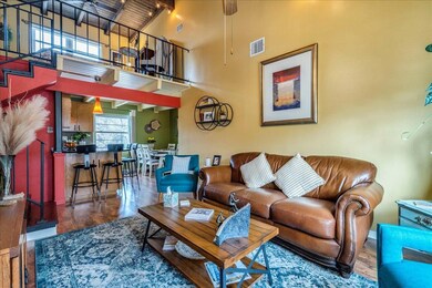 Living area with a towering ceiling and wood fini