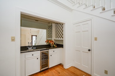  wet bar equipped with a sink, wine rack and wine fridge.