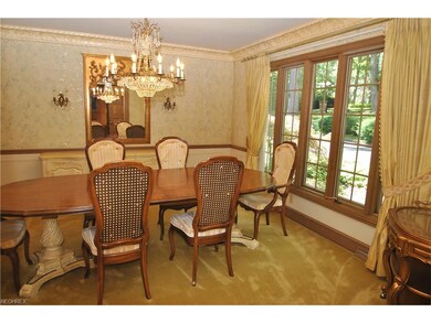 Formal dining room has exquisite chandelier & scon