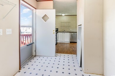 Corridor with sink and light tile patterned floors