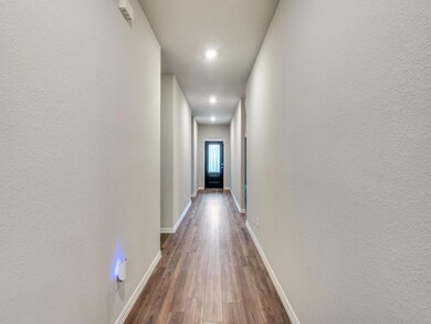 Hallway with dark hardwood / wood-style flooring