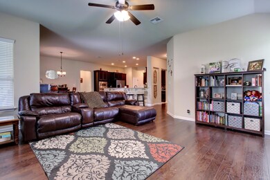 Living room featuring dark wood-style flooring, a