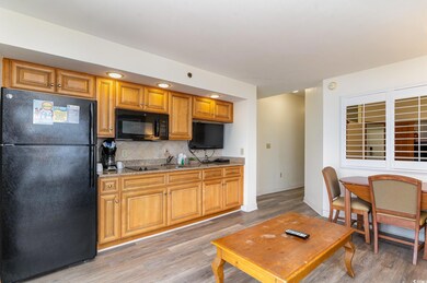 Kitchen with black appliances, decorative backspla