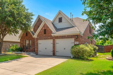 View of front of house featuring a front lawn and a garage