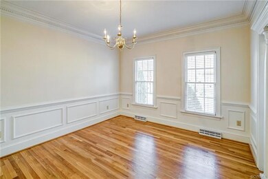 Light & bright dining room boasts a beautiful chan