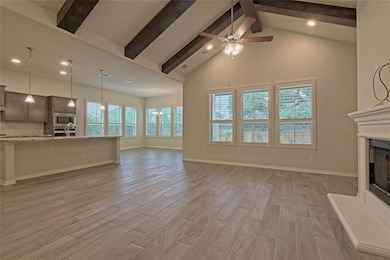 Unfurnished living room featuring light wood fini