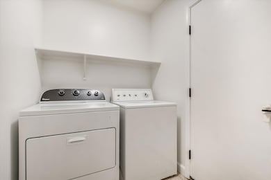 Washroom featuring washing machine and clothes dryer