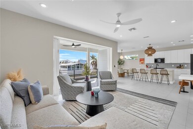 Living room with ceiling fan, light tile patterned