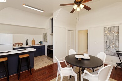 Dining room featuring light wood finished floors, lofted ceiling, and a ceiling fan