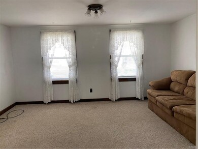FRESHLY PAINTED LIVING ROOM WITH BERBER CARPET