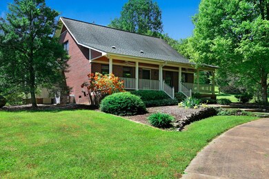 View from side, beautiful landscaped yard with rocks, fruit trees and flowers