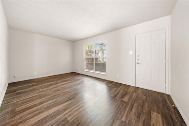 Entryway featuring dark wood-style floors and a t
