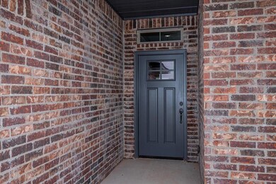 Doorway to property featuring brick siding