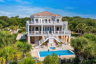 Rear view of property featuring a balcony and a pa