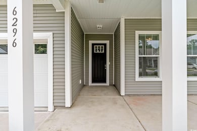 View of exterior entry with a porch
