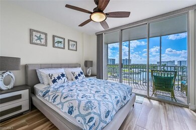 Bedroom with access to exterior, a view of city, expansive windows, ceiling fan, and wood finished floors