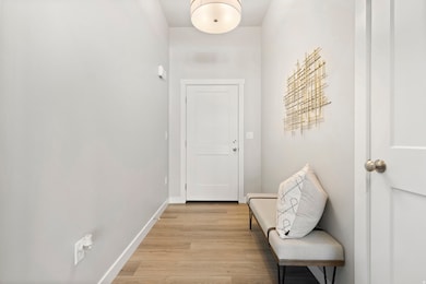 Entryway with baseboards and wood finished floors