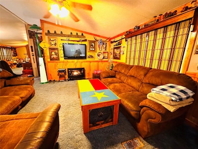 Carpeted living area with lofted ceiling, a wainsc