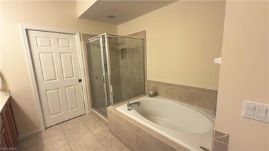 Full bath featuring tile patterned floors, a large
