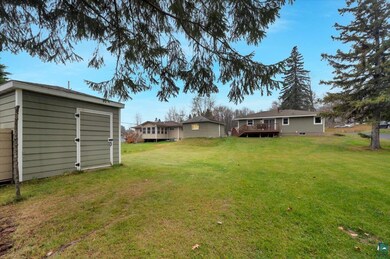 View of yard featuring a storage shed and a wooden