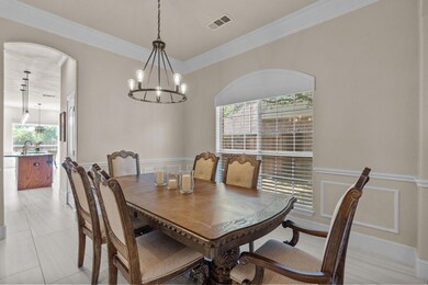 Dining area featuring visible vents, arched walkwa