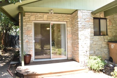 Entrance to property featuring stone siding