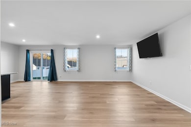 Unfurnished living room featuring light wood-type flooring and recessed lighting