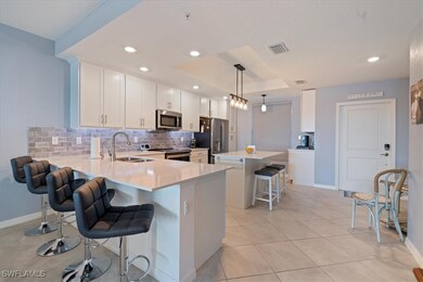Kitchen with a breakfast bar, sink, hanging light