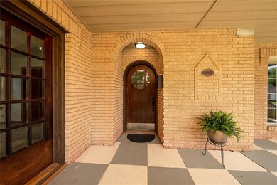Doorway to property featuring brick siding