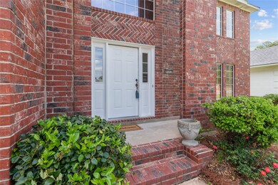 Doorway to property with a patio area