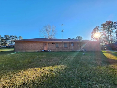 Back of house featuring a yard