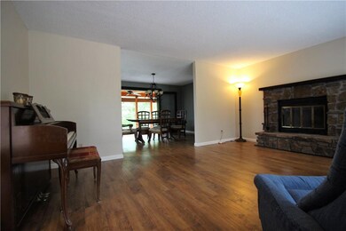 Large living area with view through dining into sunroom.
