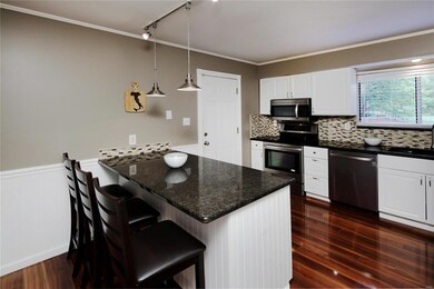 Updated eat-in kitchen with center island, glass t
