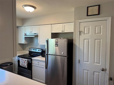 Kitchen featuring freestanding refrigerator, elec