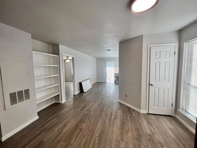 Unfurnished living room with dark wood-type flooring and a ceiling fan