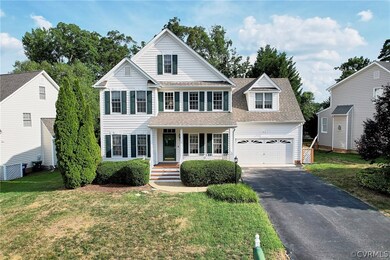 View of front of property featuring a garage, a porch, cooling unit, and a front yard