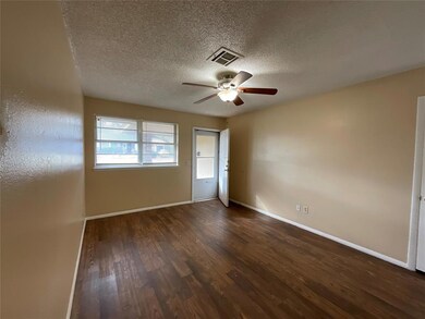 Spare room featuring ceiling fan, a textured ceili