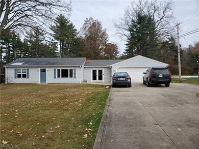Single story home featuring a garage and a front yard
