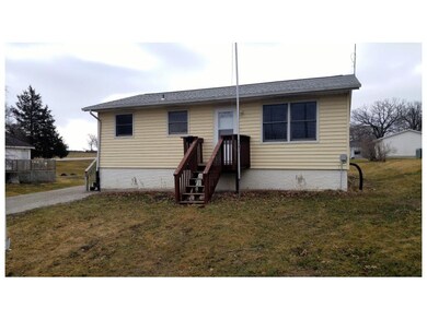 Front of house and front lawn with flag pole next 
