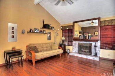 Family room with vaulted ceilings, fireplace opens to entry/living area