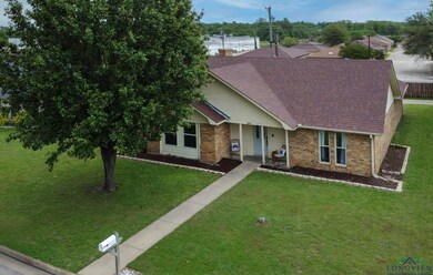 Ranch-style home featuring brick siding, roof with