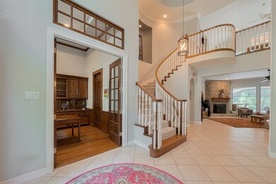 As you enter the foyer through double leaded-glass