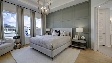 Bedroom featuring a decorative wall, light wood-s