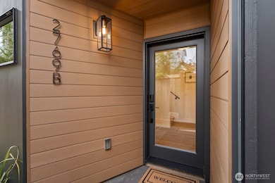 Gorgeous covered entryway wrapped with Resist siding creates a warm entry